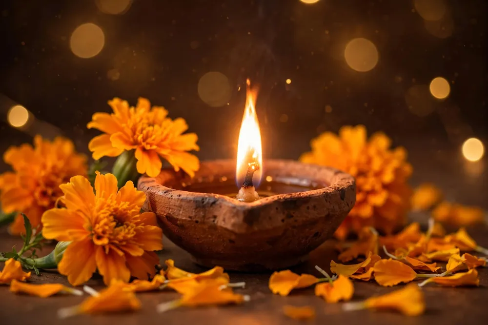 Benefits of reading Hanuman Chalisa daily - lit diya with marigold flowers